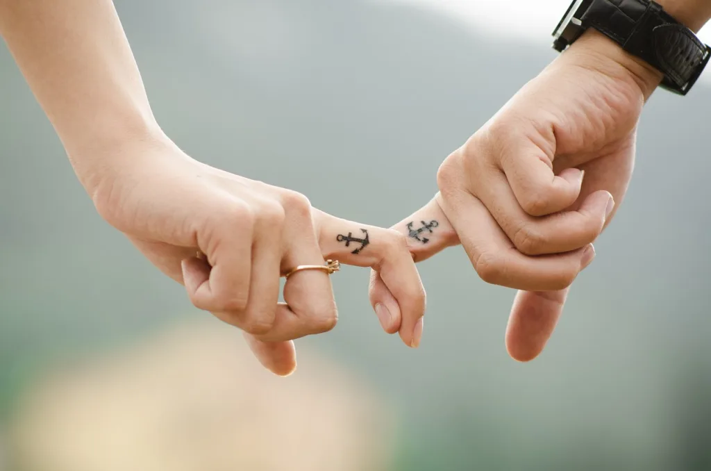 couple holding hands with fingers, True love, trust and communication