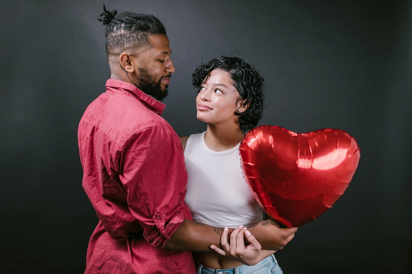 Couple Looking at Each Other While Holding a Red Heart Shaped BalloonFeelings for a Guy Dealing with disappointment Handling rejection Finding confidence