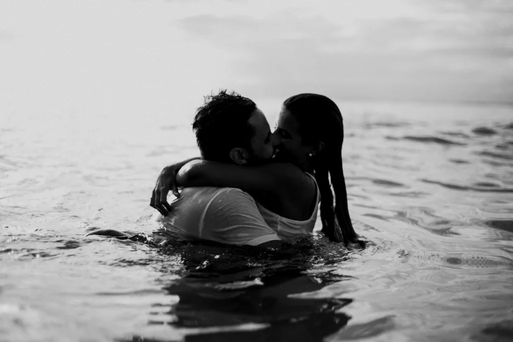 Man and Woman Kissing Together on Body of Water. Rebound relationship Romantic relationship emotions and loneliness Breakup