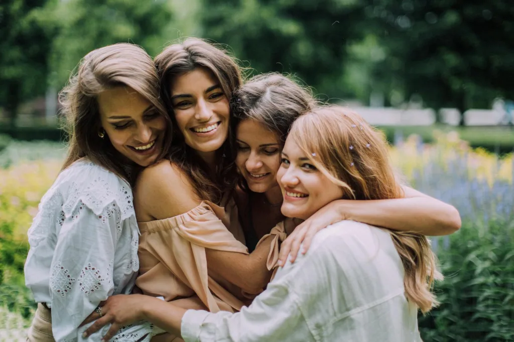Women Hugging and Smiling. Rediscovering Passion, love after a breakup, manage emotions, after a breakup