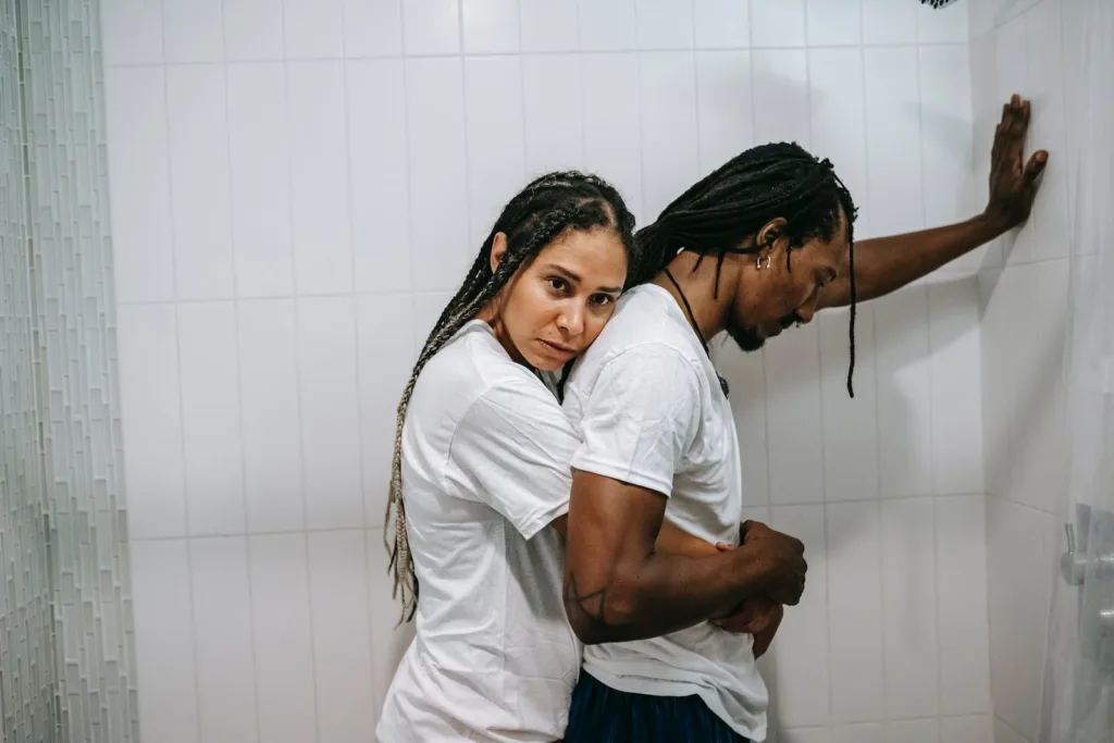Sad black loving couple hugging in bathroom after argument. Acts of Love, realm of relationships.