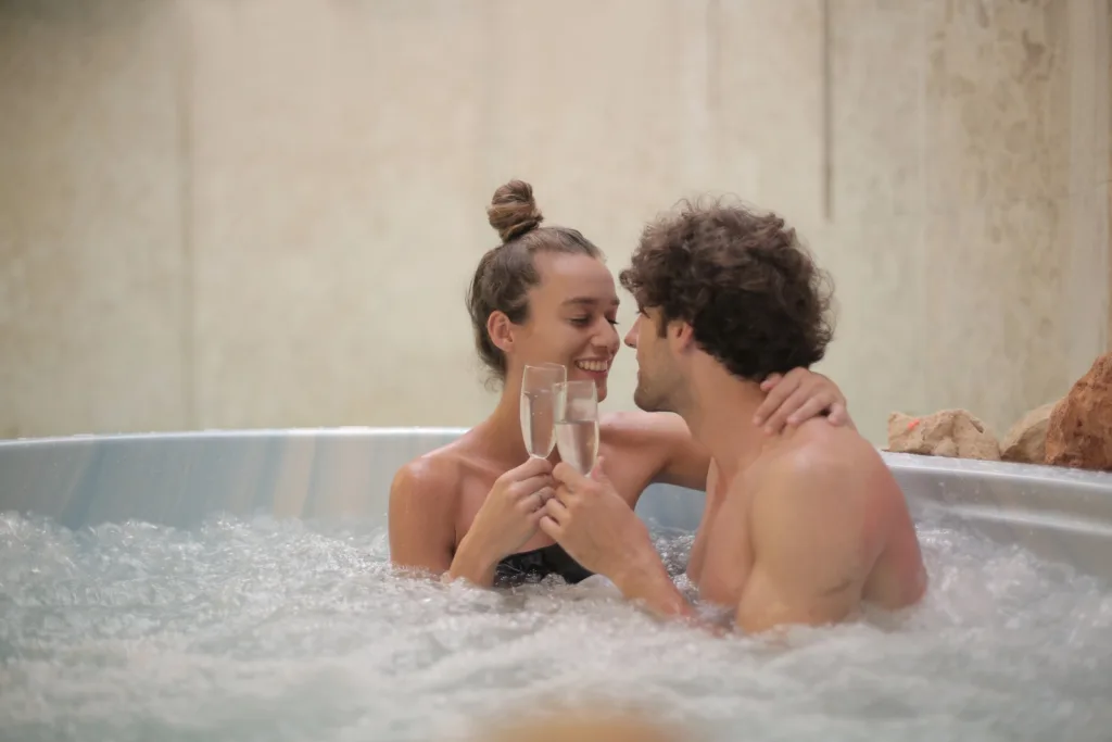 Happy couple having fun in jacuzzi during romantic date Addressing Poor hygiene Cultivating Growth Growth in relationships