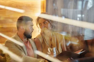 Man Sitting Beside Woman Holding a Menu Card