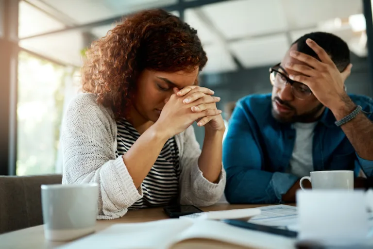 Shot of a young couple looking stressed out in their relationship. Clingy boyfriend Red Flag Behaviors jealousy and insecurity toxic relationship emotional dependence