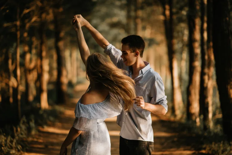 man and woman dancing at center of trees. Is there a solution to one-sided chemistry? Building mutual chemistry.