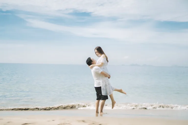 Happy couple enjoying vacation together on seashore