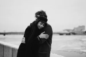 Grayscale Photo of Couple Hugging Each Other