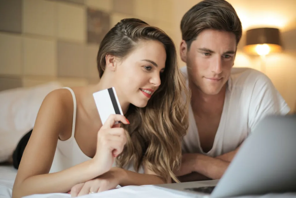 Cheerful couple making online purchases at home. Independence and togetherness, strong and healthy relationship.