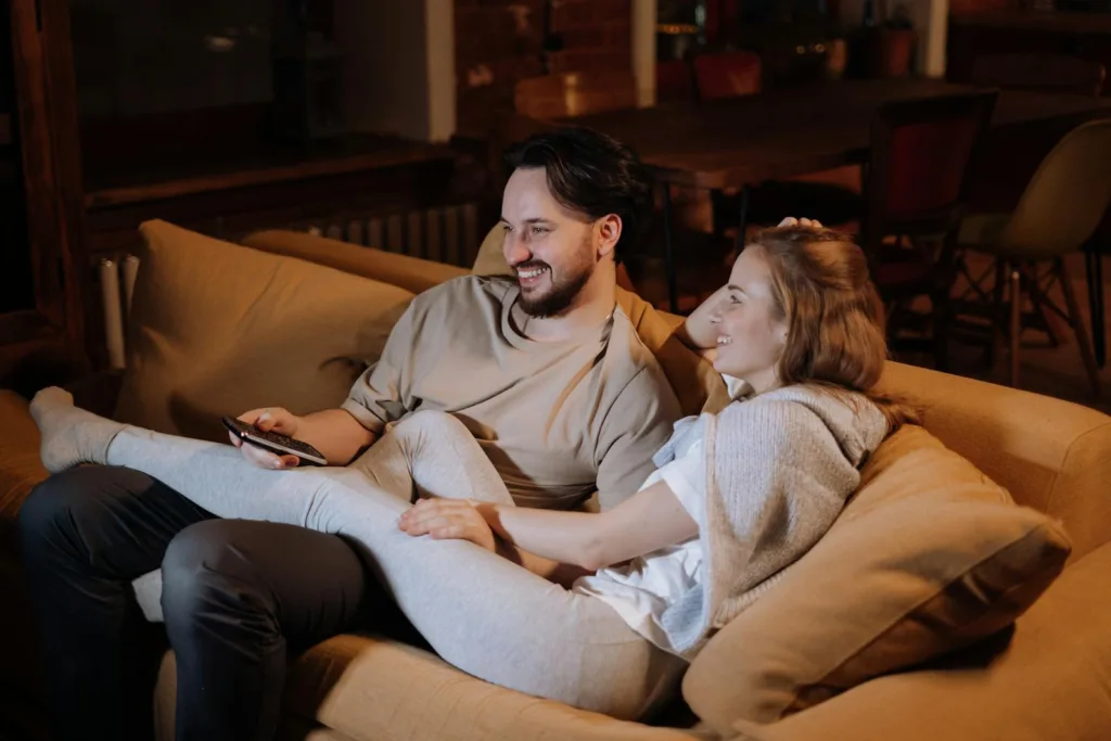Man and Woman Sitting on Couch. Couples closer together, Emotional connection, Rekindle intimacy