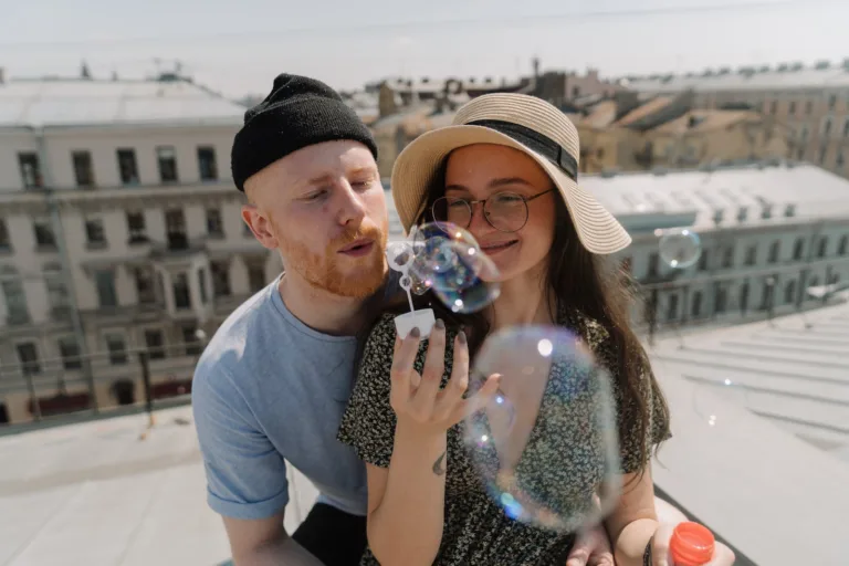 Man in Blue Crew Neck T-shirt Holding Woman in White and Black Polka Dot Dress. Love and Infatuation, healthy relationships.