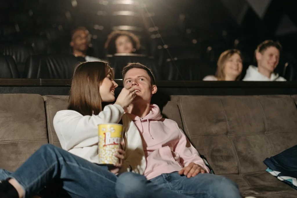 Couple Watching Movie in a Cinema Theater Eating Popcorn. Your partner's hidden passion, effective communication. overcoming misunderstandings, healthy relationship